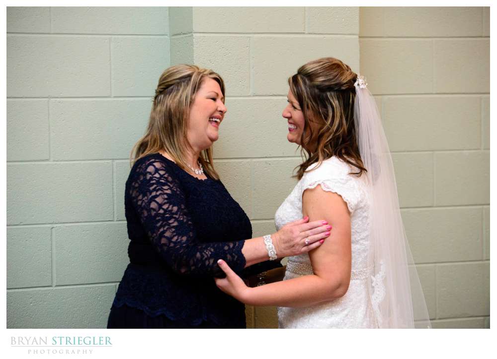 mother talking to bride before she leaves