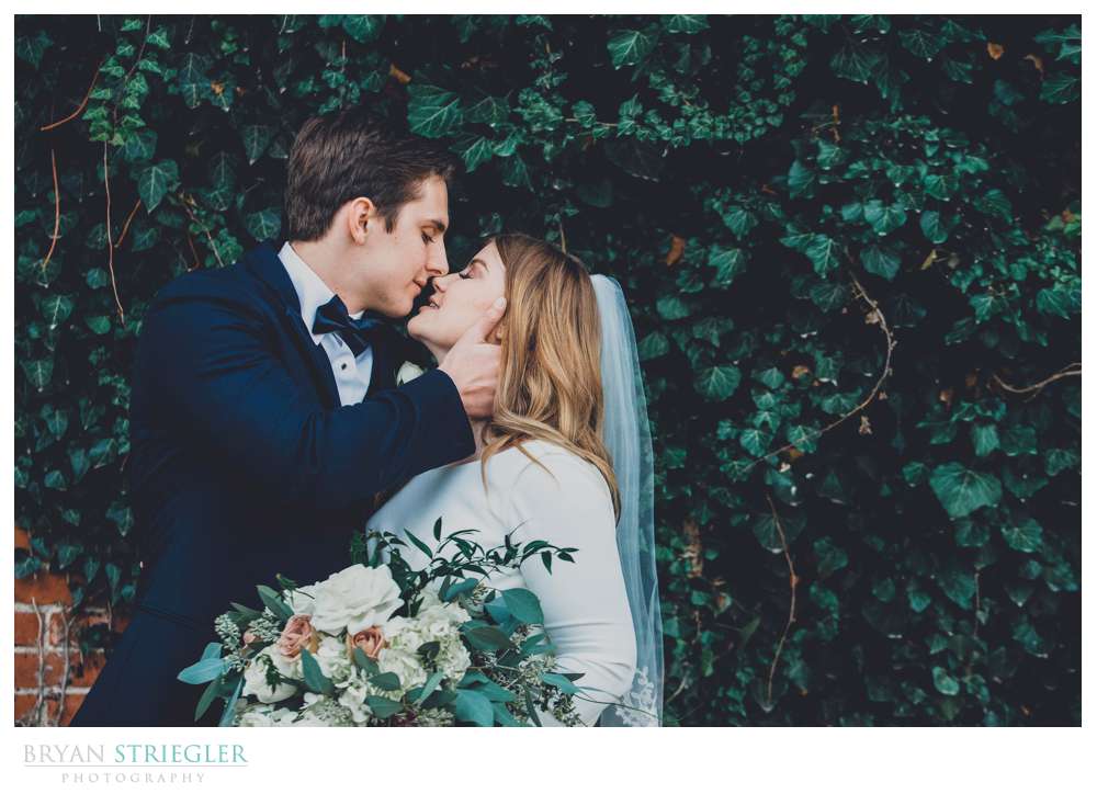 couple in front of ivy wall