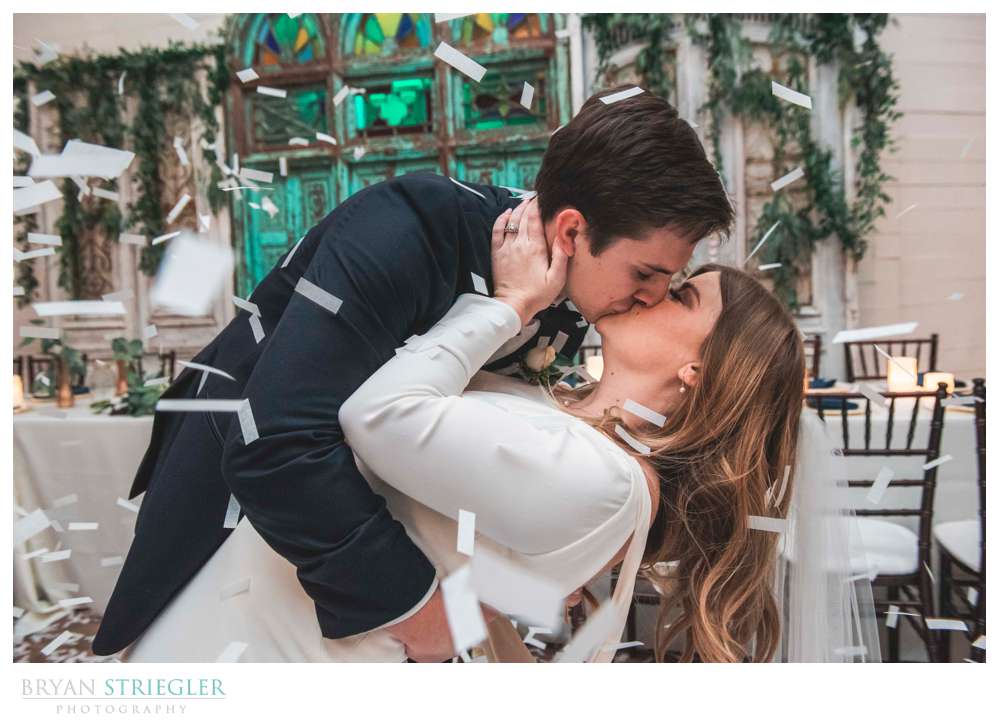 couple kissing as confetti falls