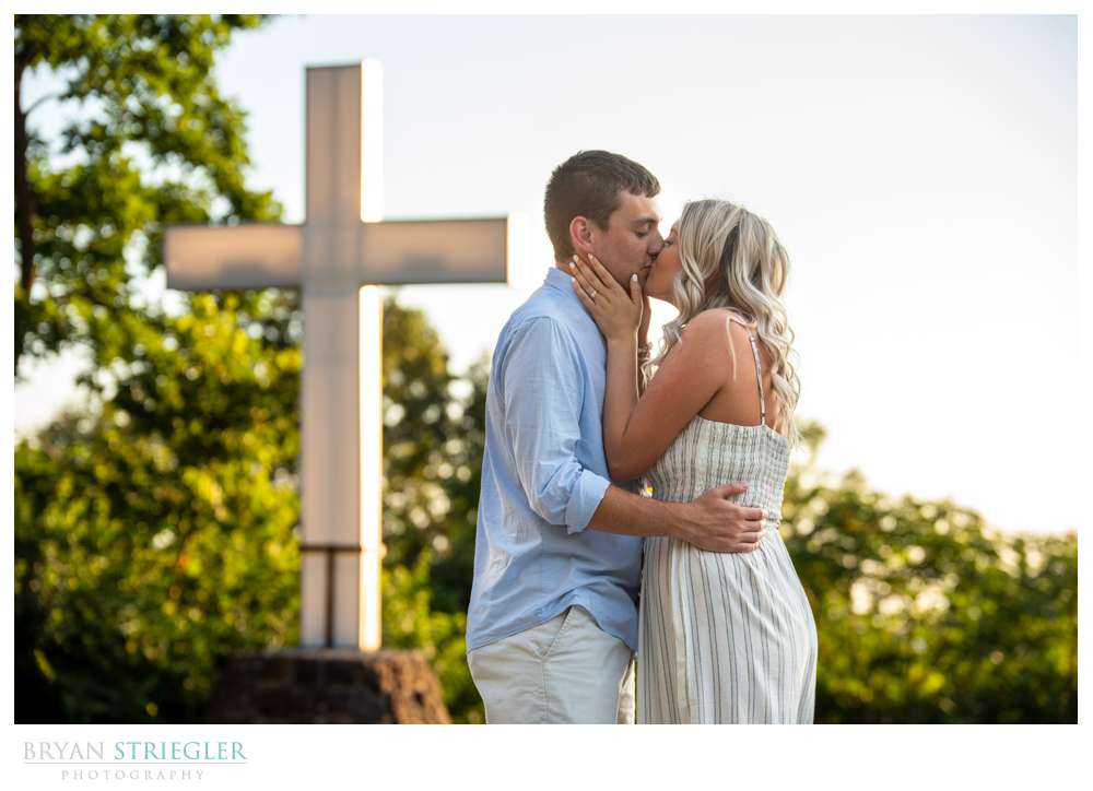 kissing in front of cross at Mount Sequoyah