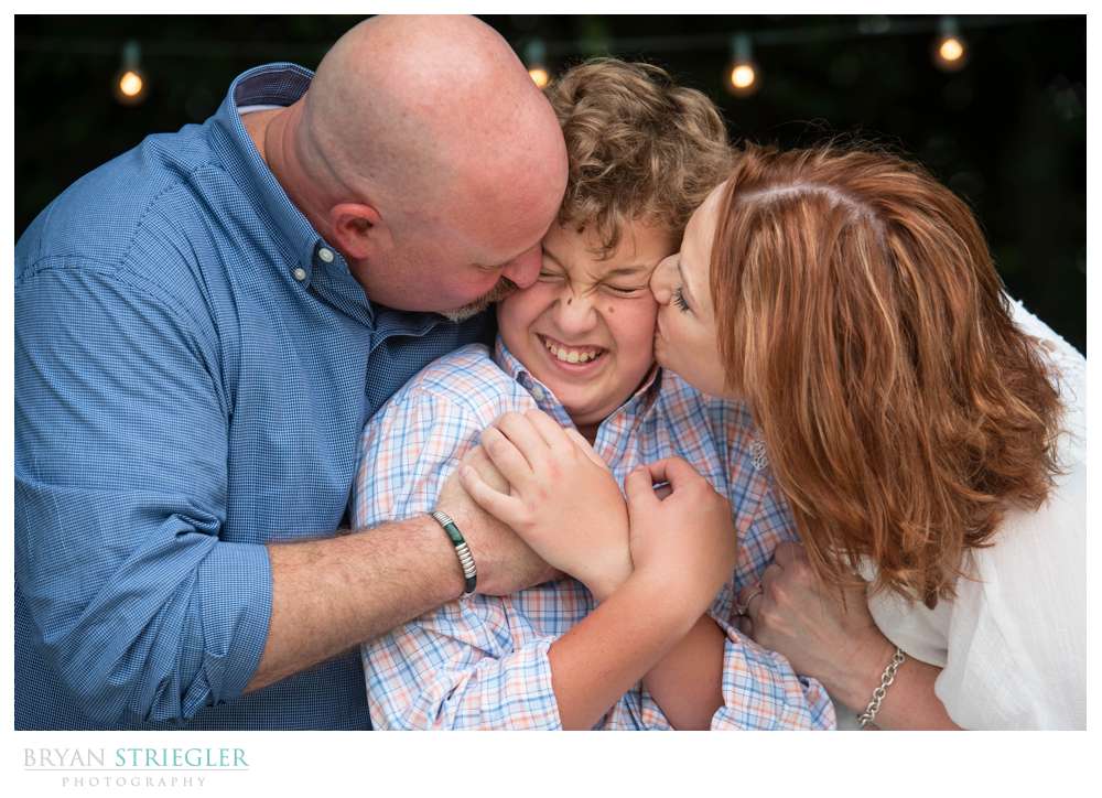 engagement photo kissing son on both cheeks