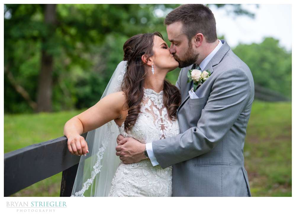 wedding couple against fence