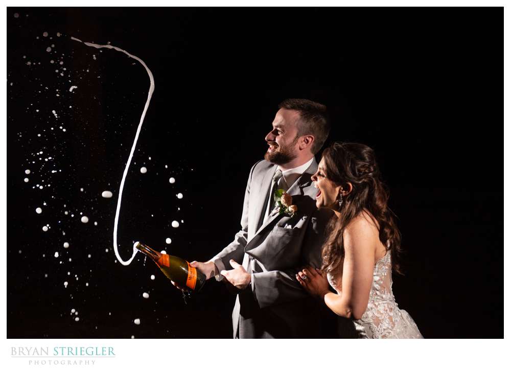 couple shooting champagne
