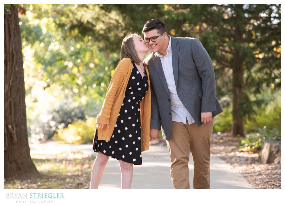kiss on the cheek engagement photo