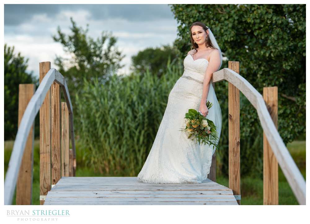bride leaning on bridge