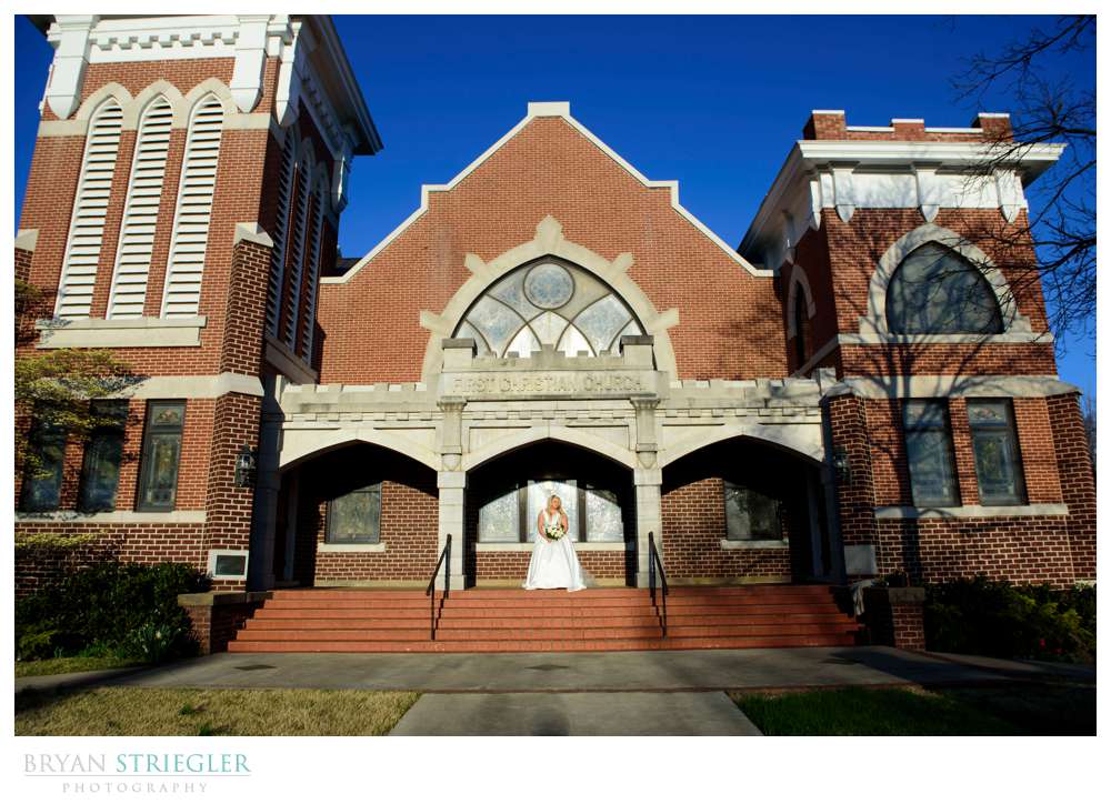 bride on steps of church in Fayetteville