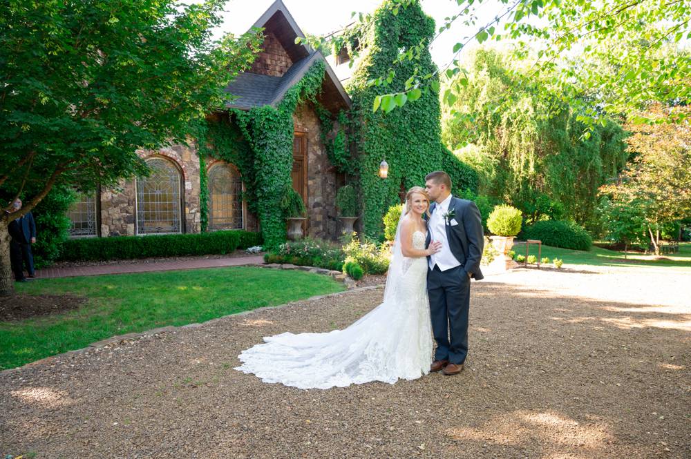bride and groom kissing in front of Matt Lane Farm