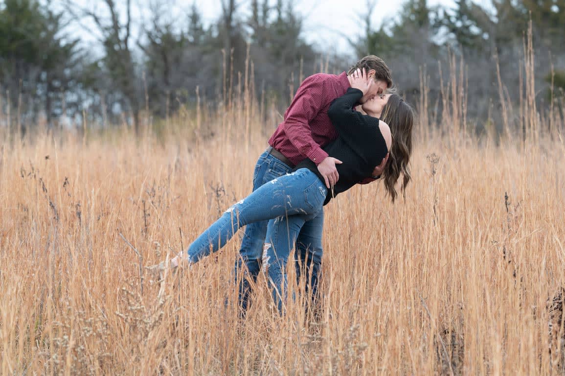 couple in field with high grass in Kansas City