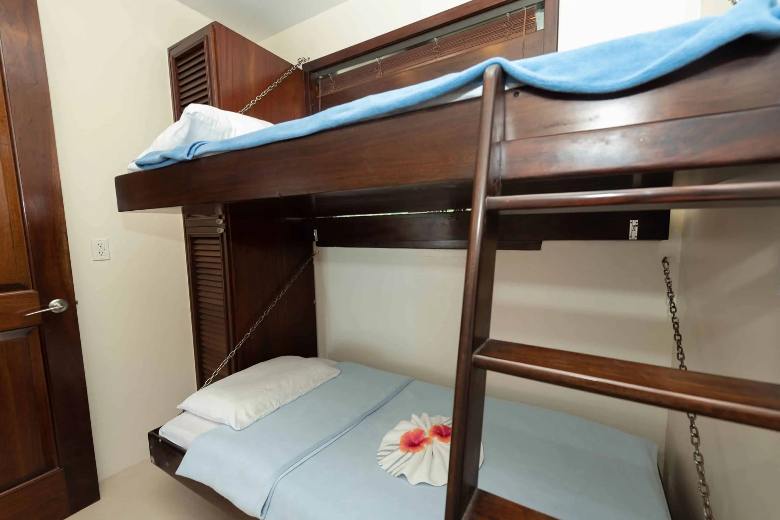 Bunk room bunks made up with fresh linens and turndown flowers