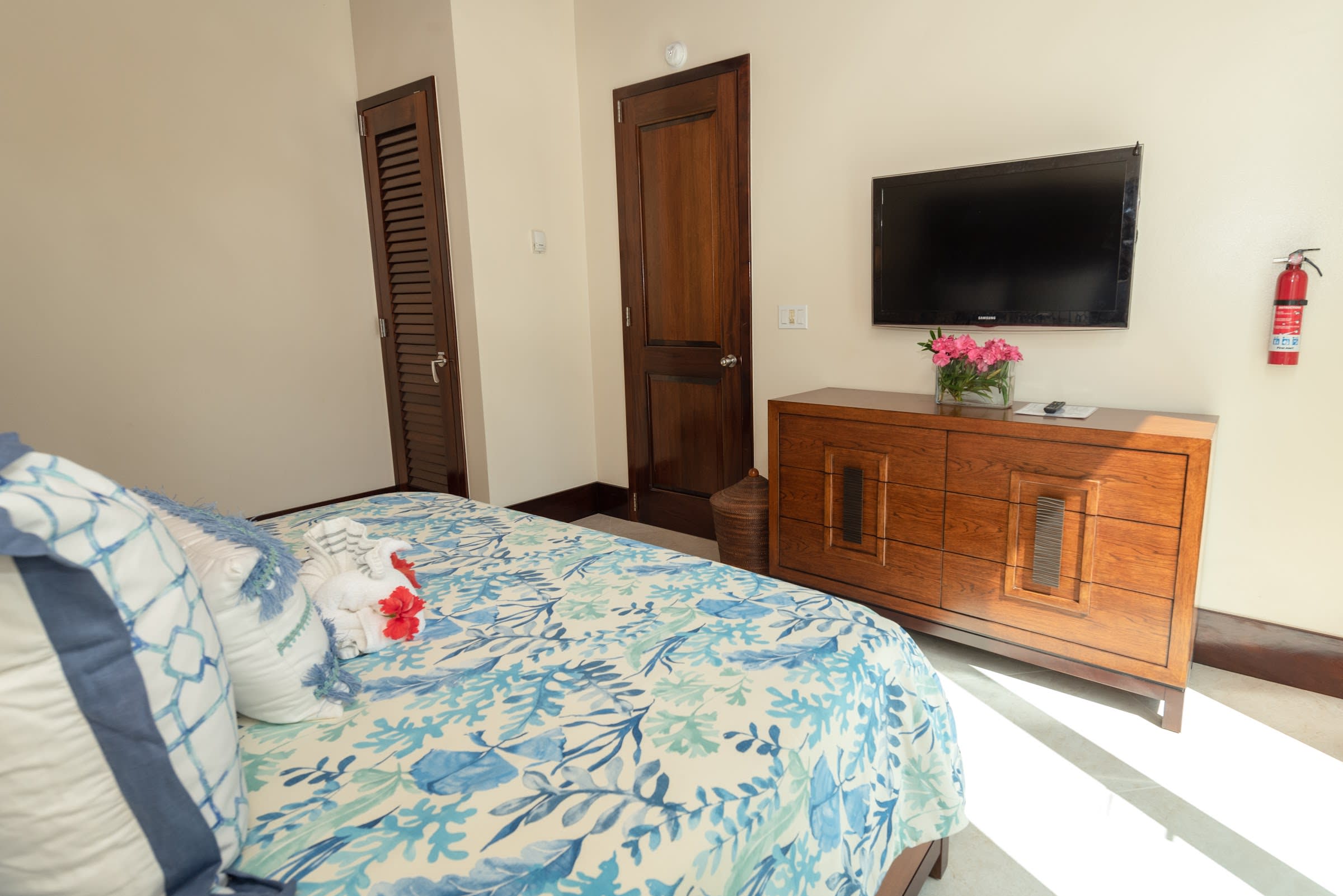 Contemporary guest bedroom with entertainment center and direct garden access.