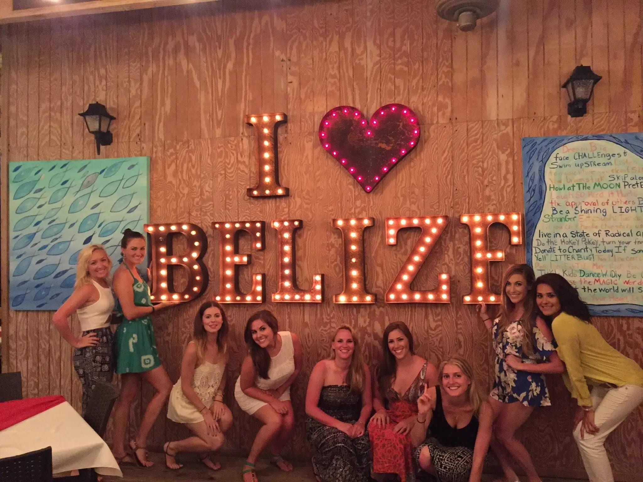Guests posing beside the I Love Belize sign