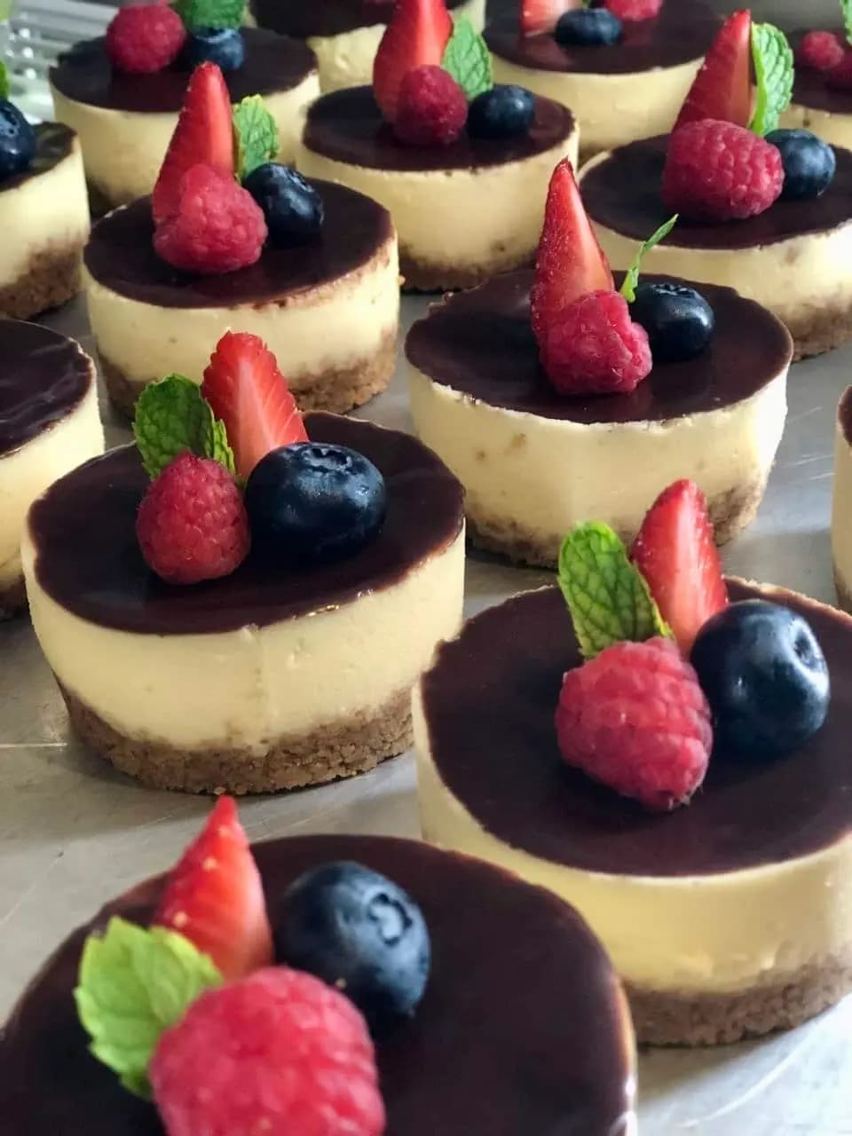 Mini cheesecakes topped with fresh berries