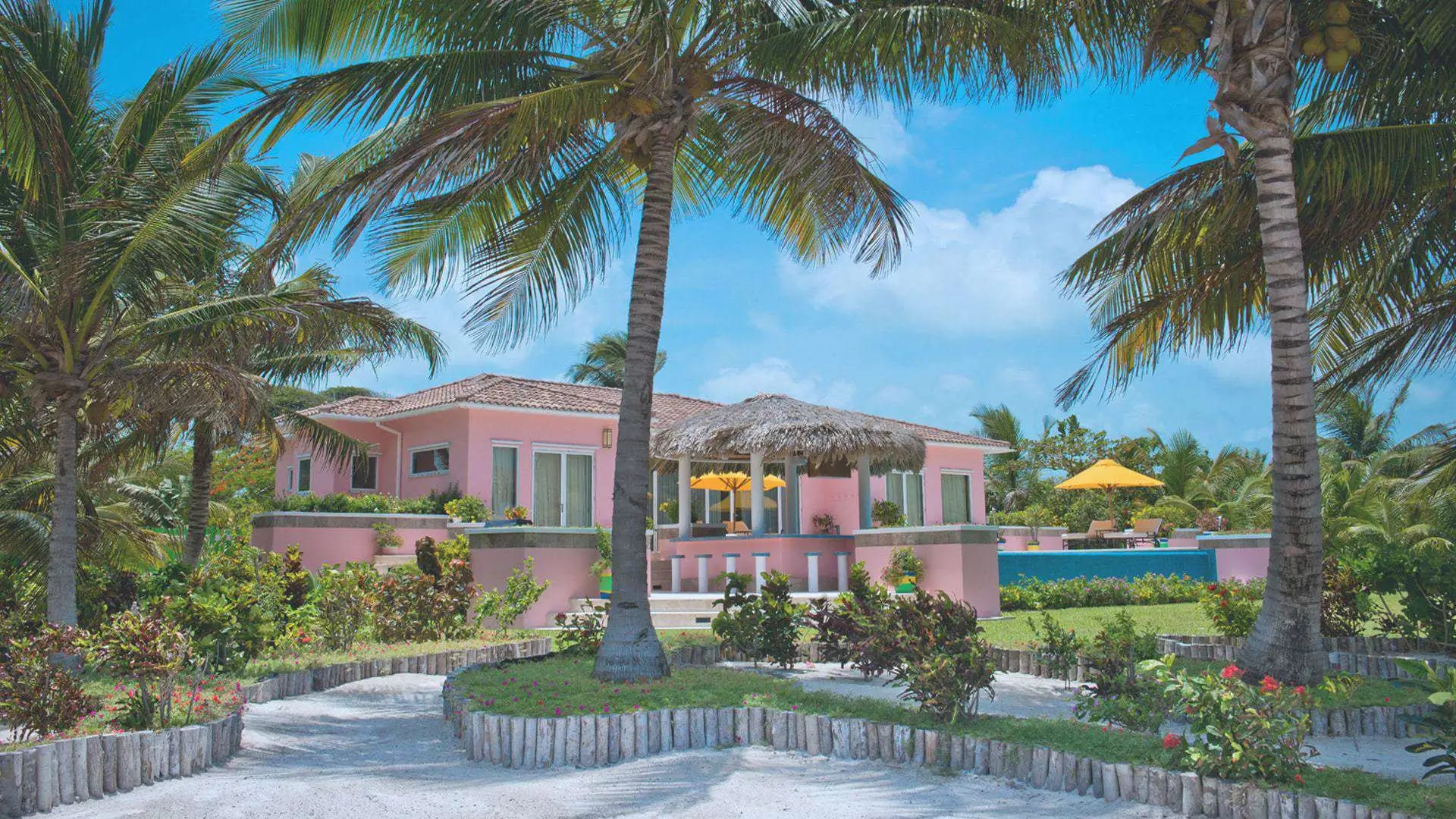 Canary Cove beachfront villa with turquoise water and palms on Ambergris Caye