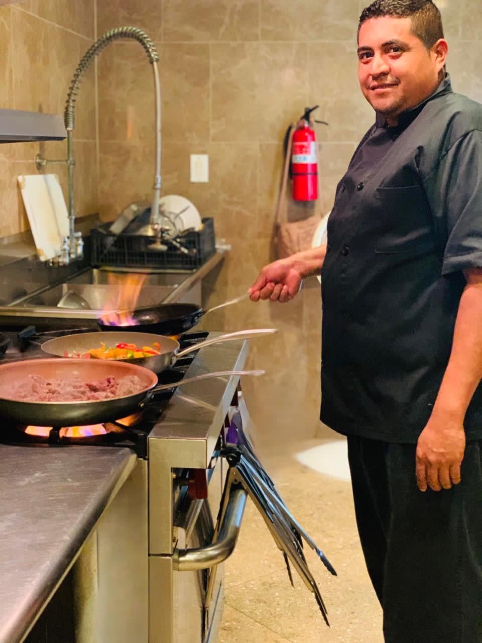 Chef Marvin searing at the kitchen range