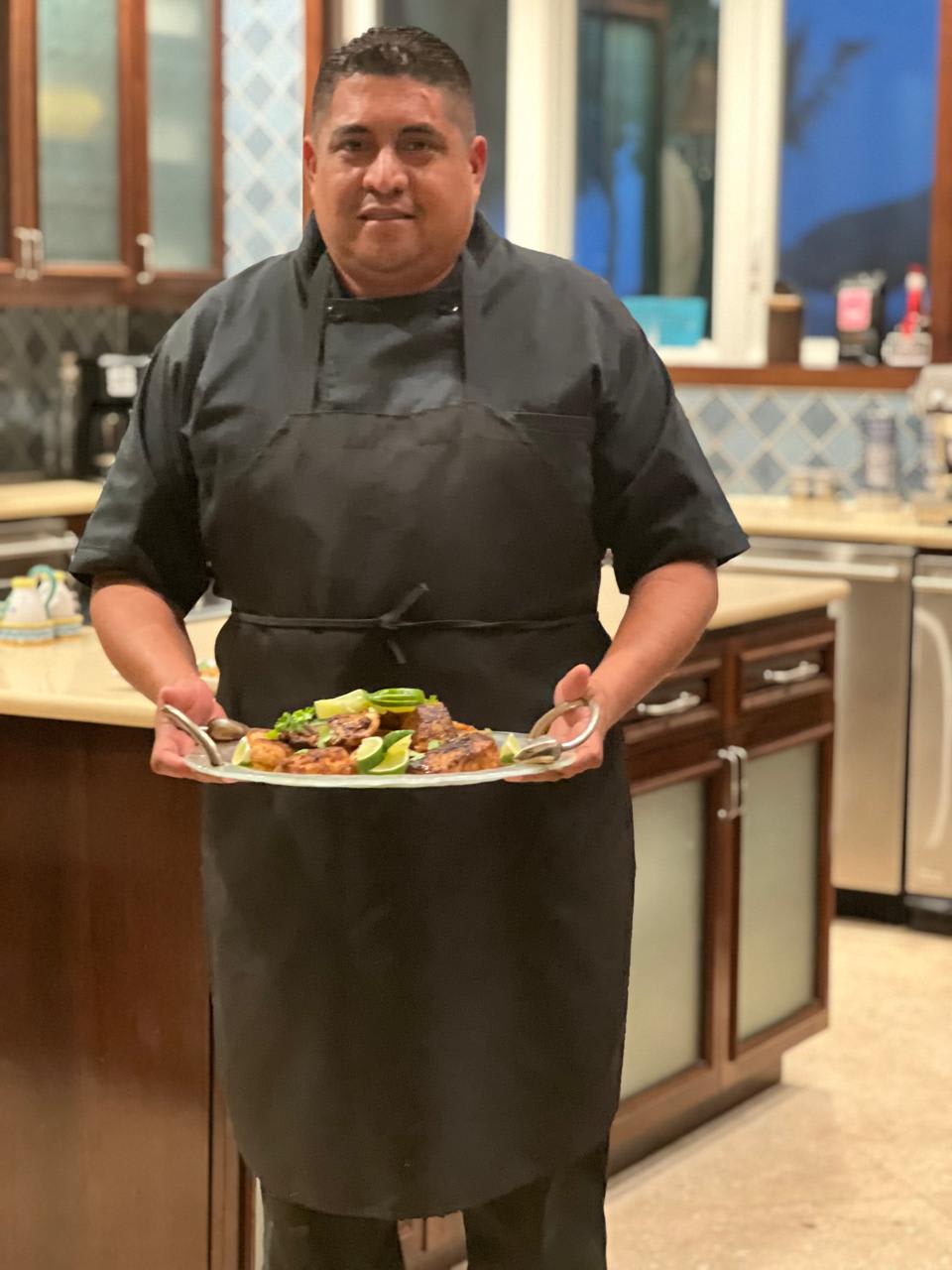 Chef Marvin presenting a plated dish in the villa kitchen
