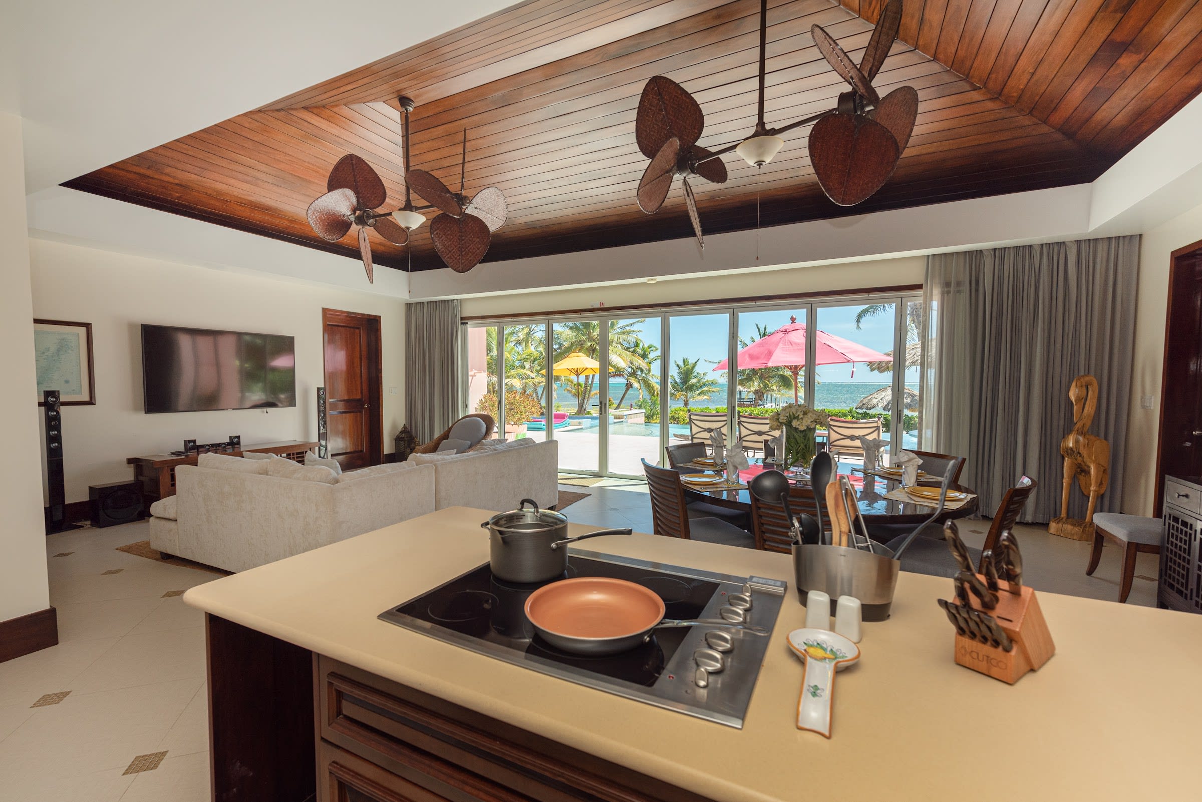 Luxurious oceanfront master bedroom with woven seating nook and private veranda.