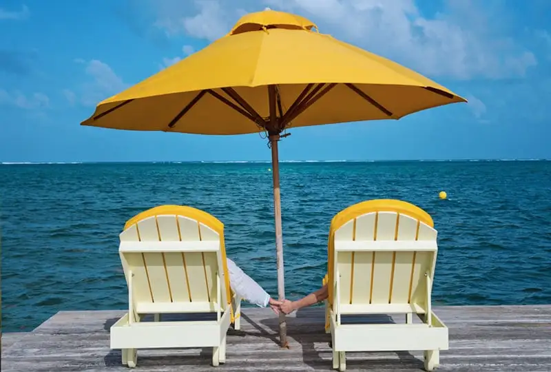 Couple relaxing by the water with sunset views