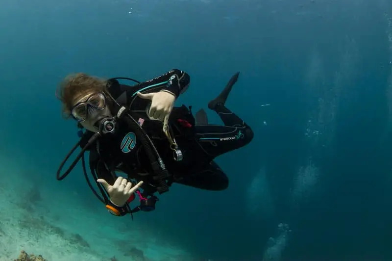 Diver underwater surrounded by clear blue water