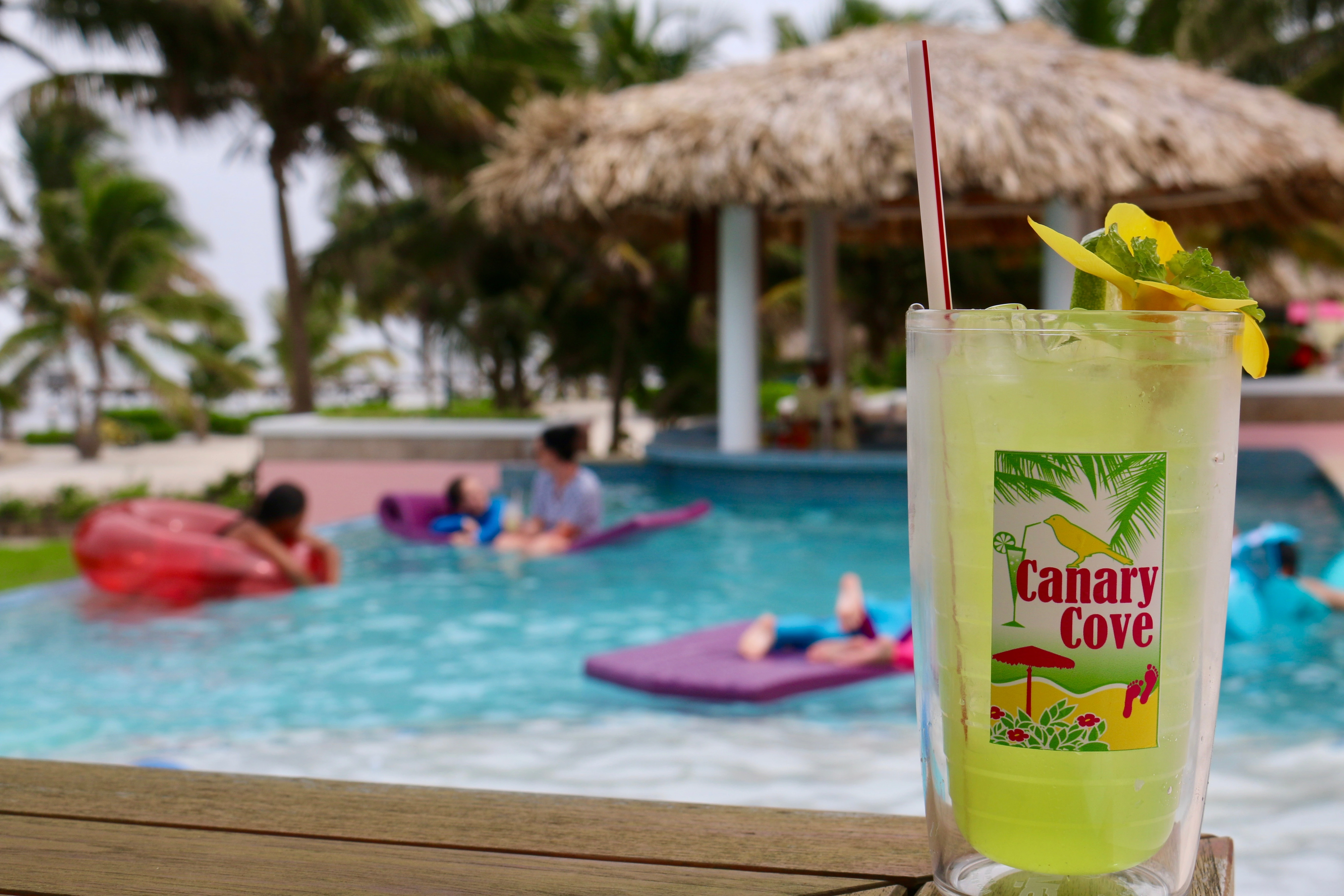 Canary Cove logo on a drink at the poolside