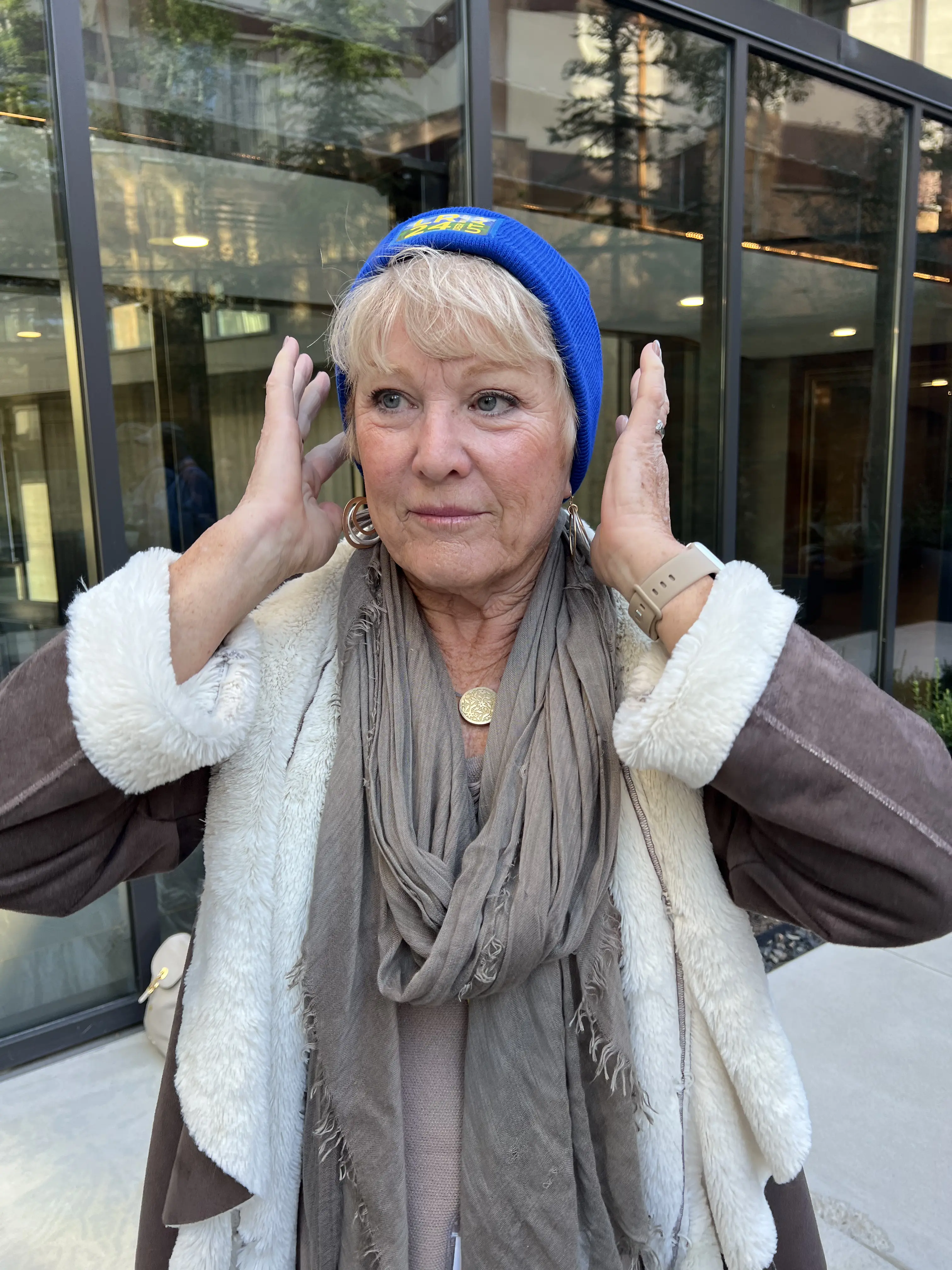 Attendee laughing while wearing a beanie during an outdoor retreat moment