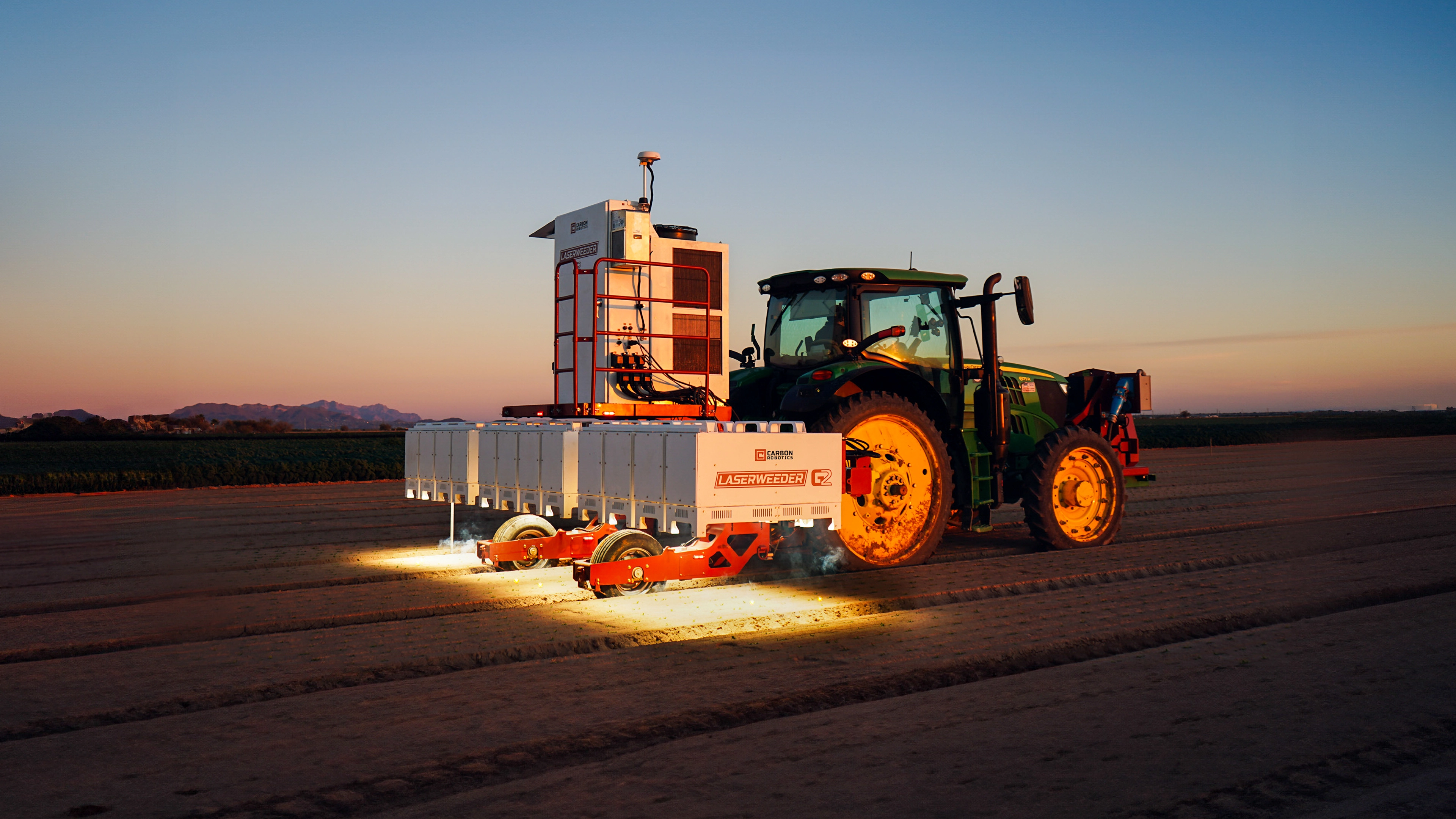 Carbon Robotics LaserWeeder G2 operating at sunset in a field