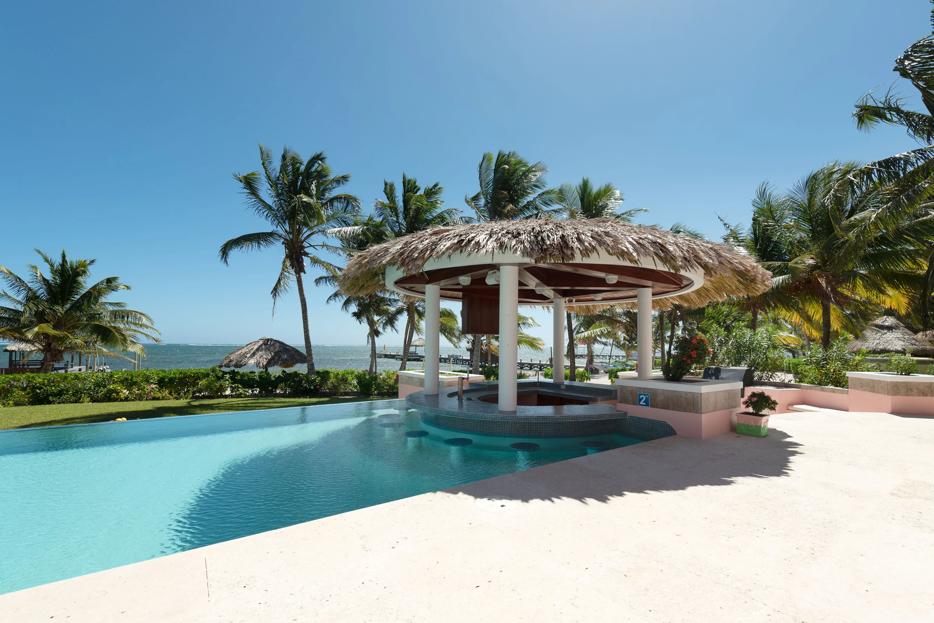Infinity pool and swim-up bar with villa view