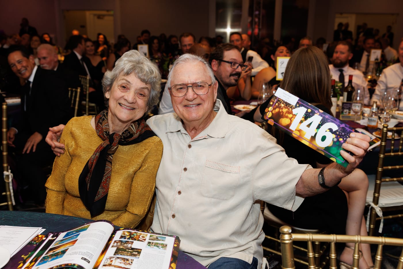 Guests holding their paddle number at the 2025 Advocacy Auction