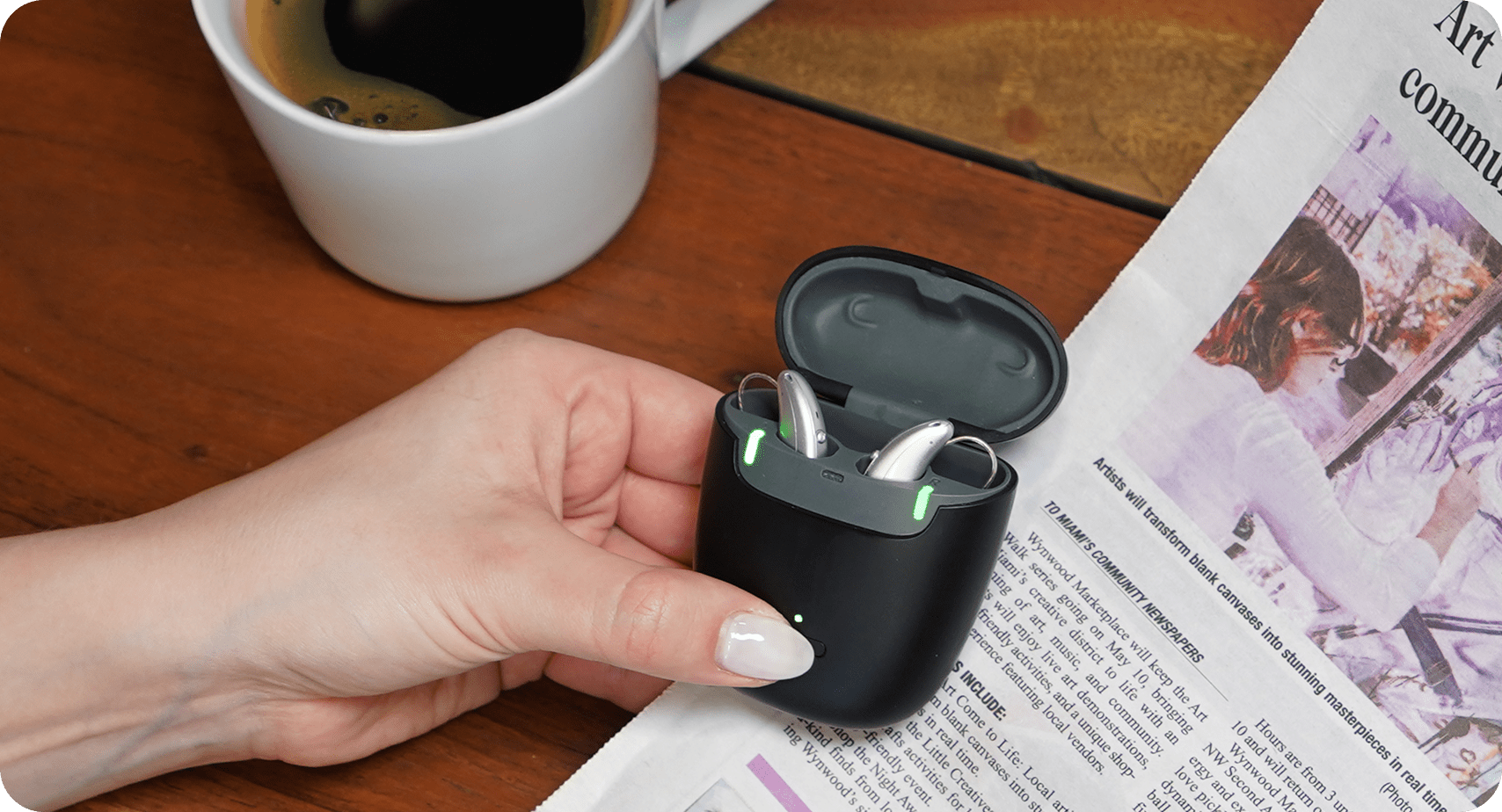 hearing aids at the table with coffee and newspaper