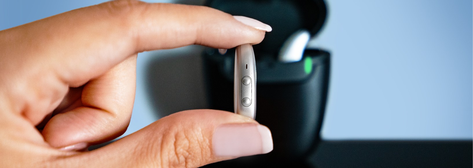 woman holding hearing aids