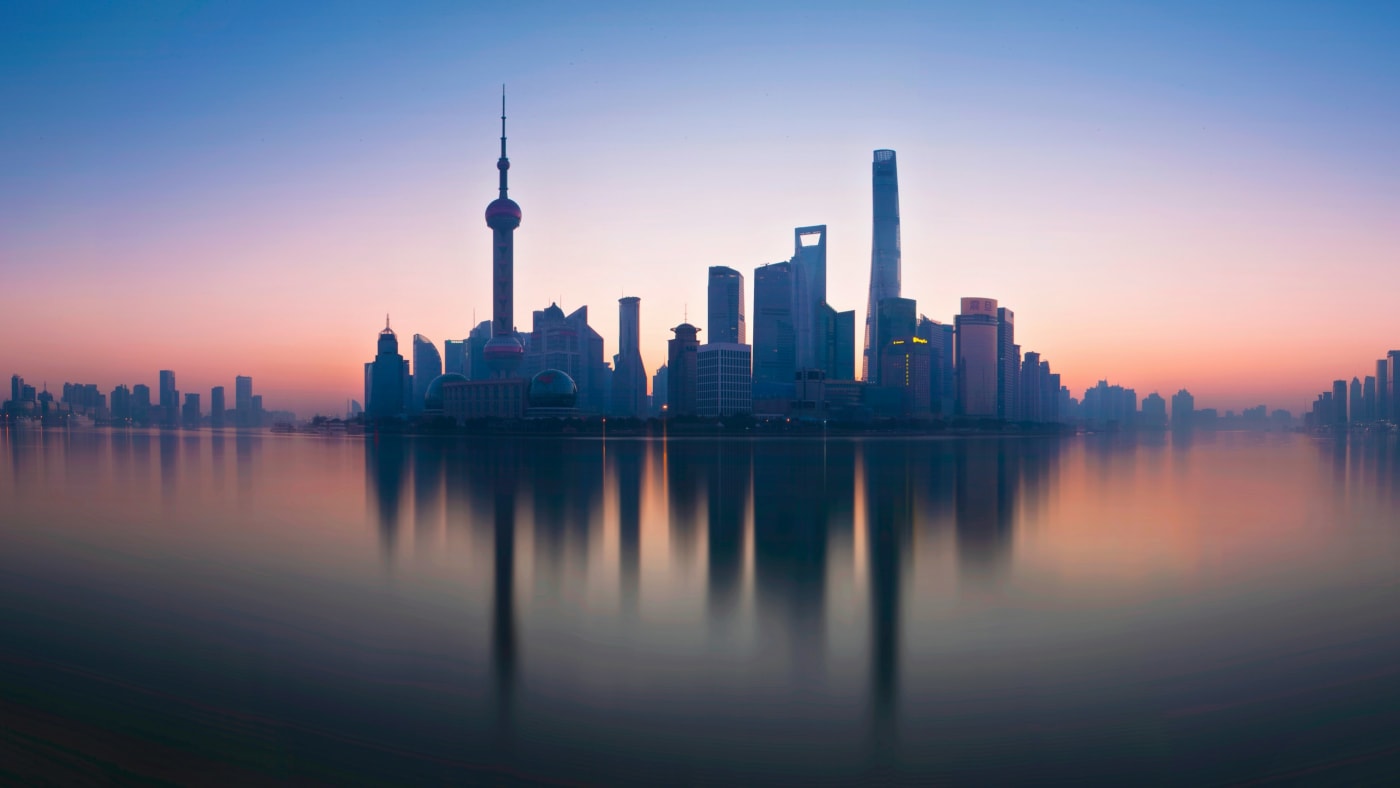 Lujiazui financial district reflected in the Huangpu river, Shanghai — dividend withholding tax for foreign shareholders