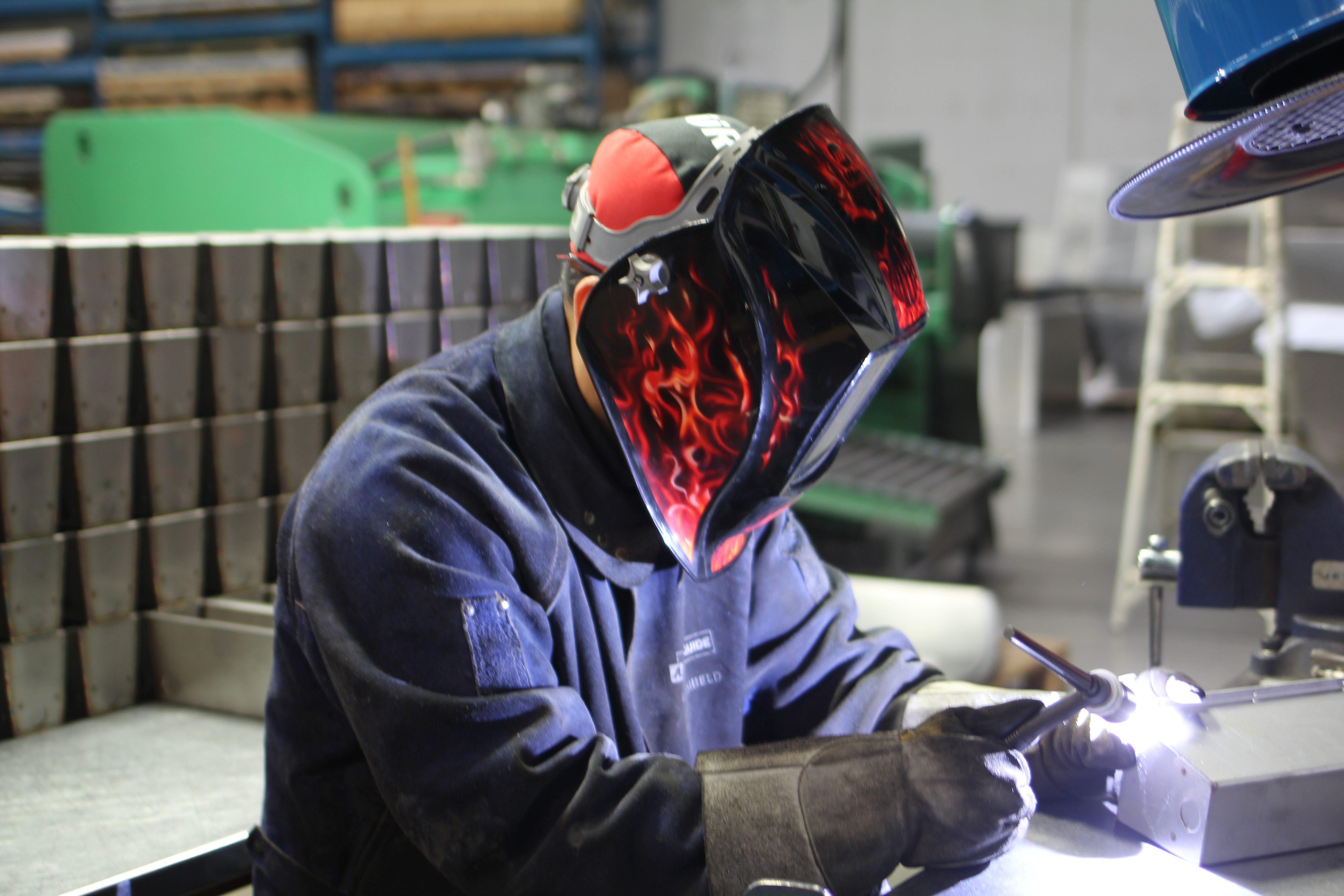 Overview of FortiFab's welding bay with multiple stations and safety partitions.