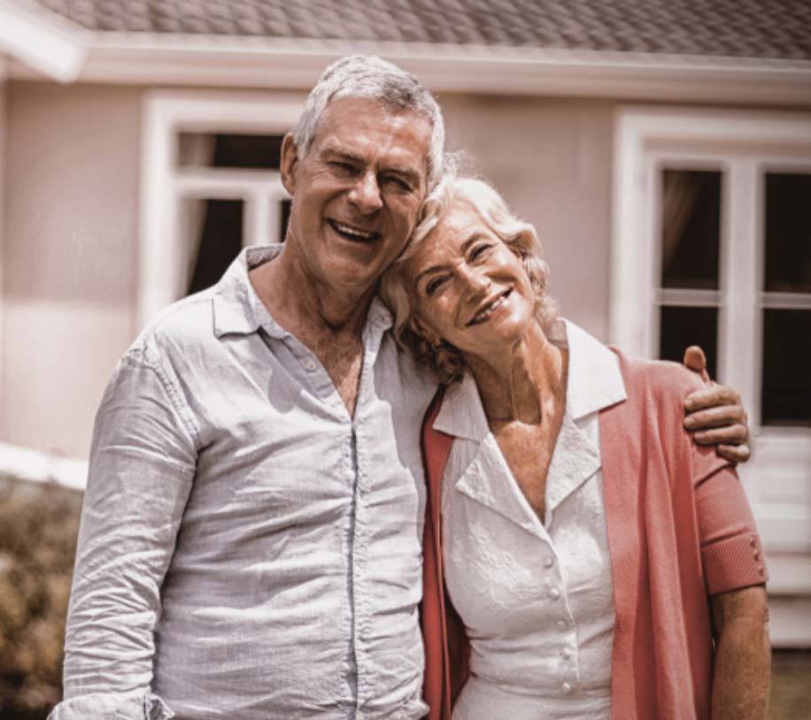 Senior couple outside their home