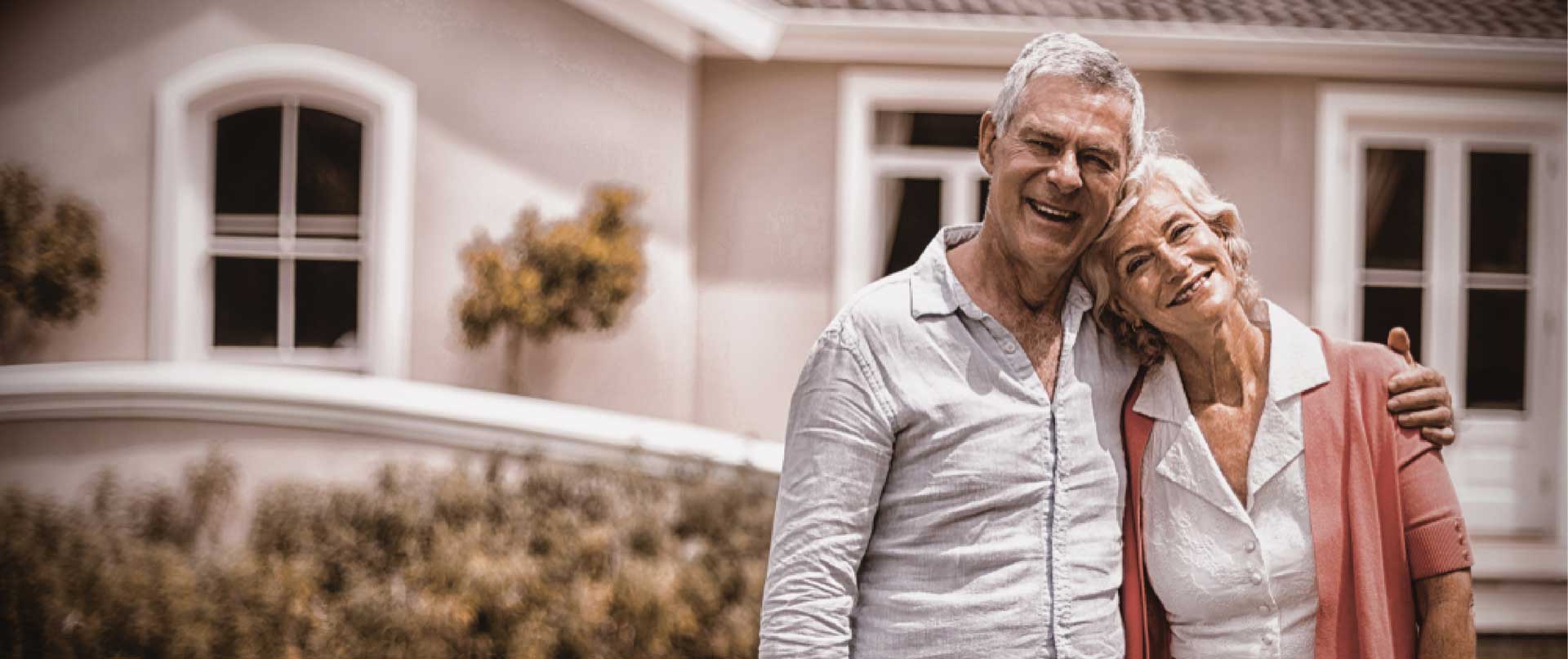 Senior couple outside their home