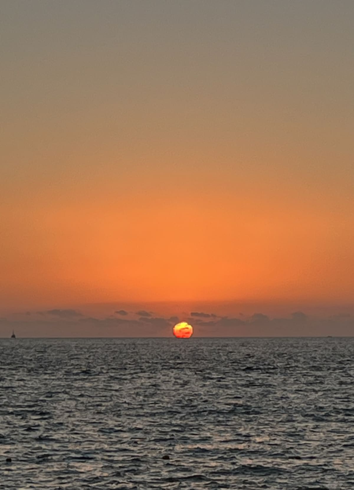 Sunset over Puerto Vallarta beach with vibrant orange and pink sky