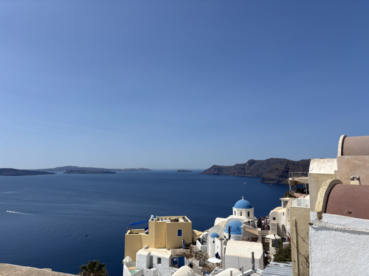 Stunning view of Santorini with white buildings and blue domes perched on cliffs overlooking the Aegean Sea