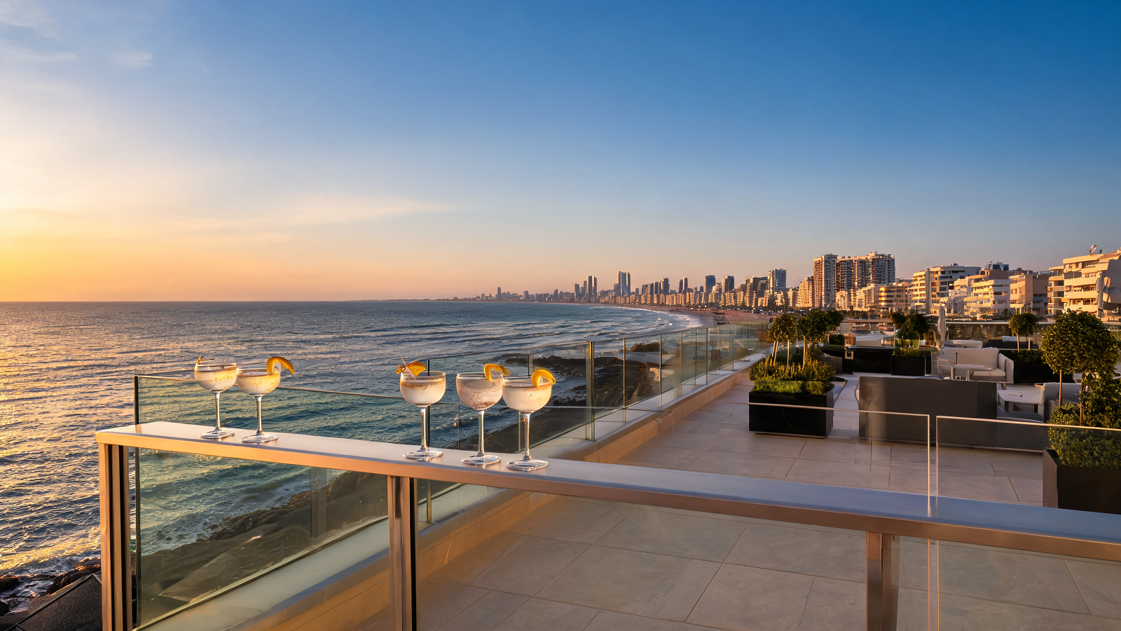 A kosher rooftop terrace in Tel Aviv at sunset overlooking the Mediterranean