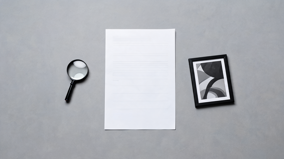 A professional condition report, a loupe and a small framed contemporary print
