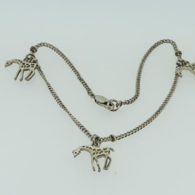 Silver necklace with giraffes image