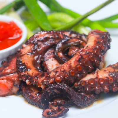 Tapas Style Small Dishes - Octopus in Herb Wine Sauce image