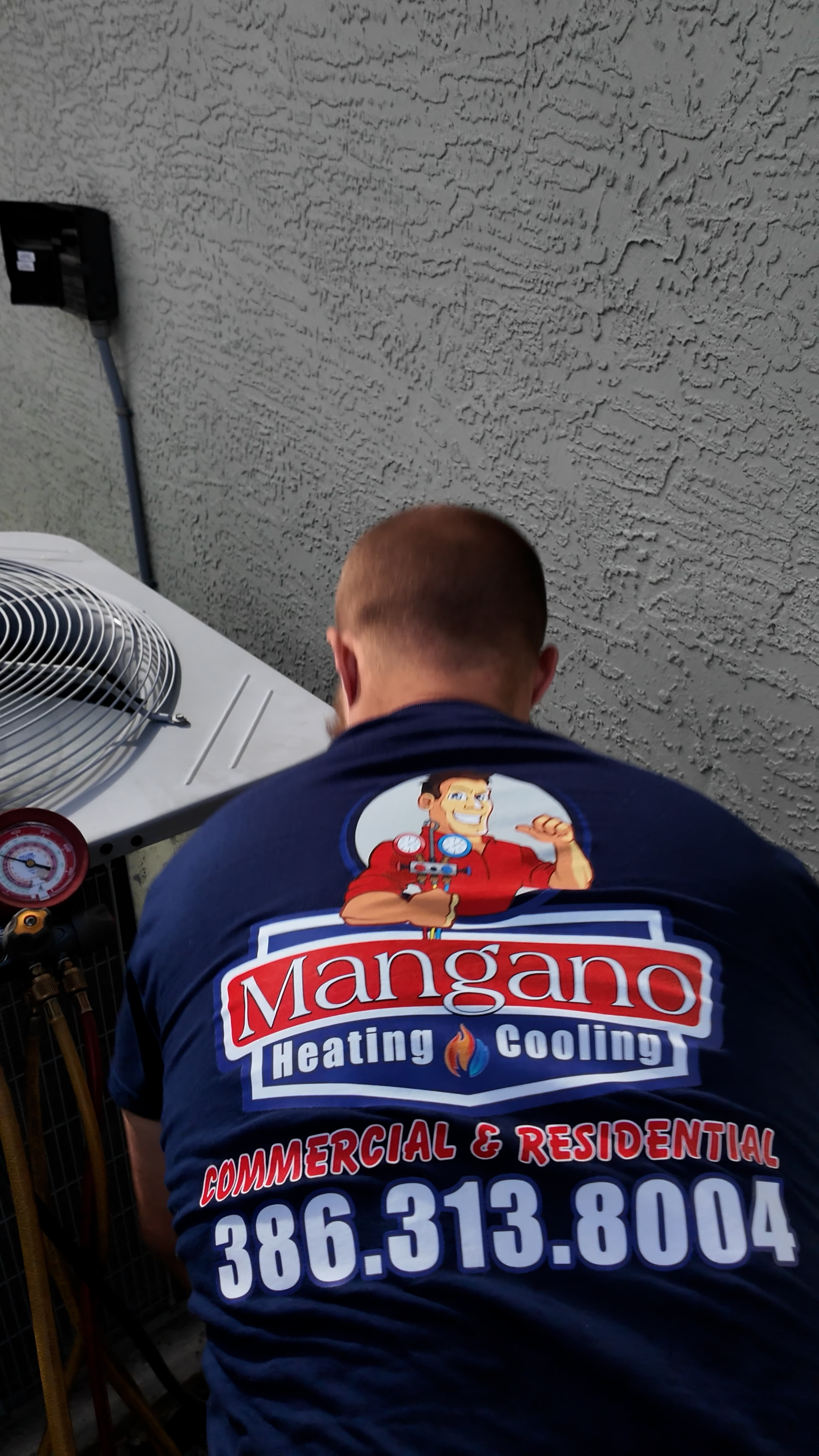 Mangano Heating & Cooling branded technician shirt — family-owned HVAC team in Palm Coast, FL