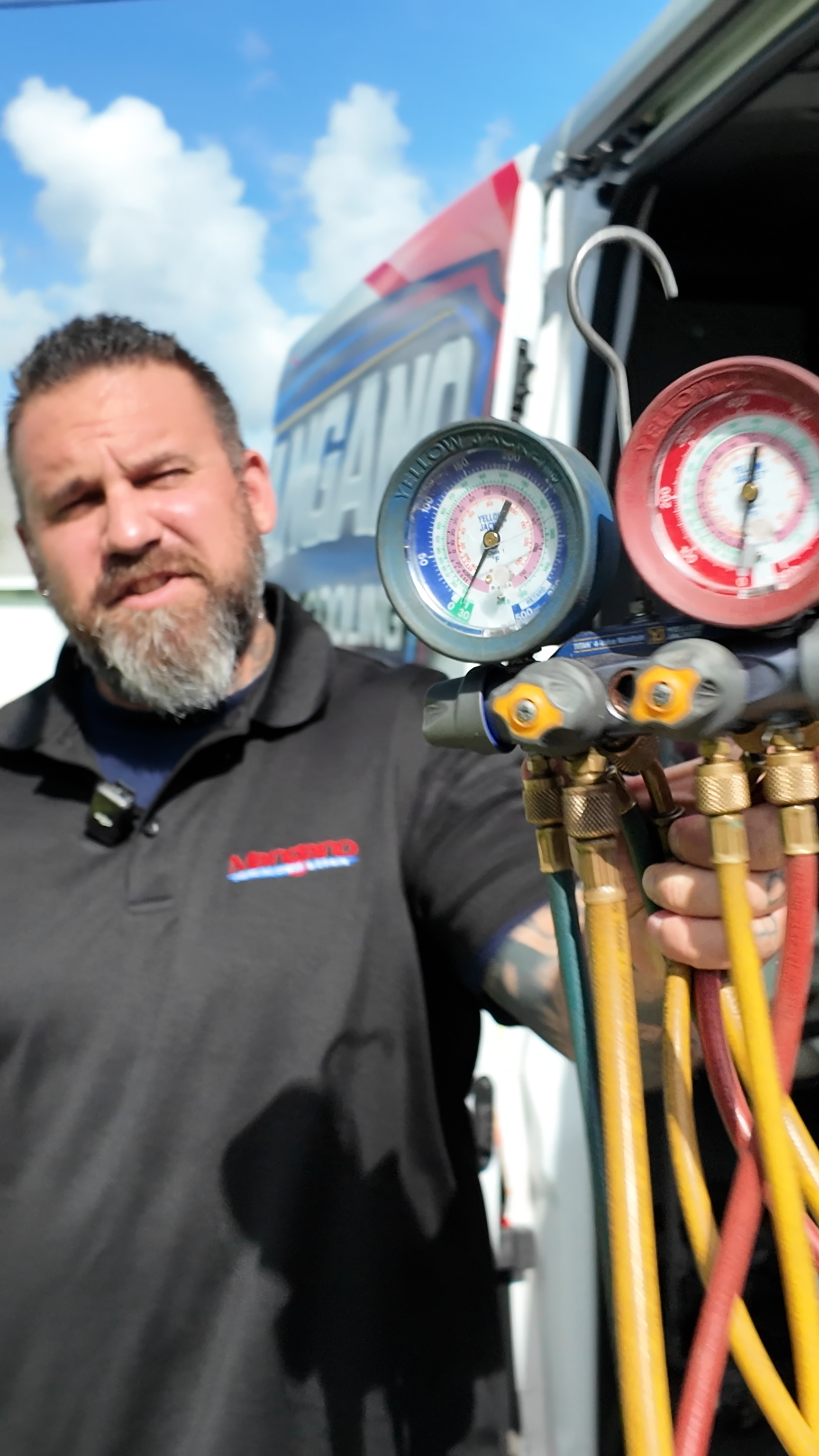 Jon Mangano, owner of Mangano Heating & Cooling, holding HVAC tools — Palm Coast, FL
