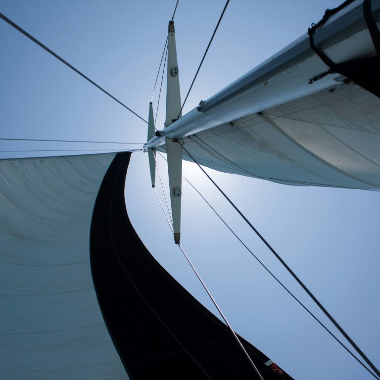SV Undertoad sailing in calm coastal waters at golden hour