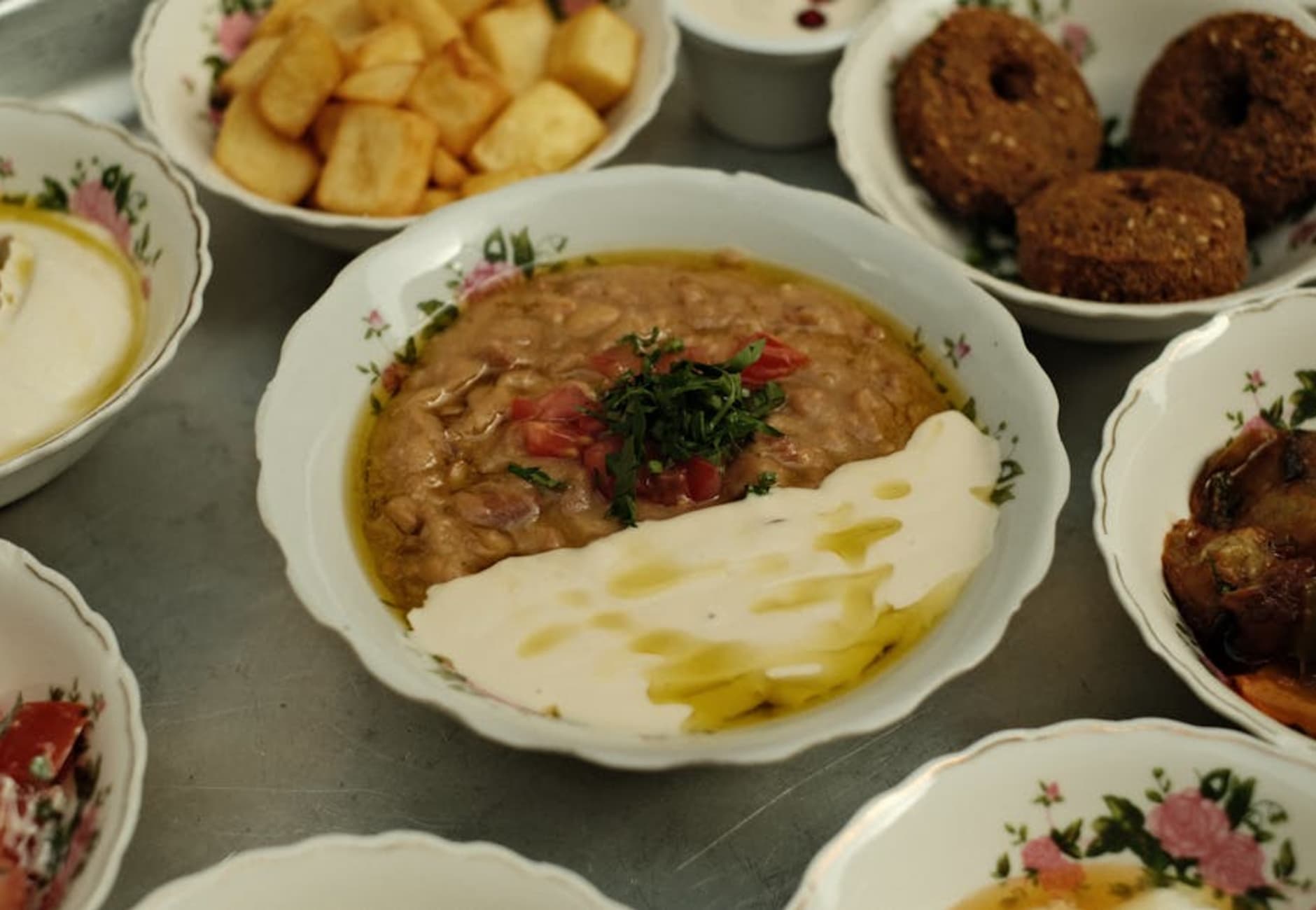 Spread of Arabic food including hummus, kebabs, and mezze