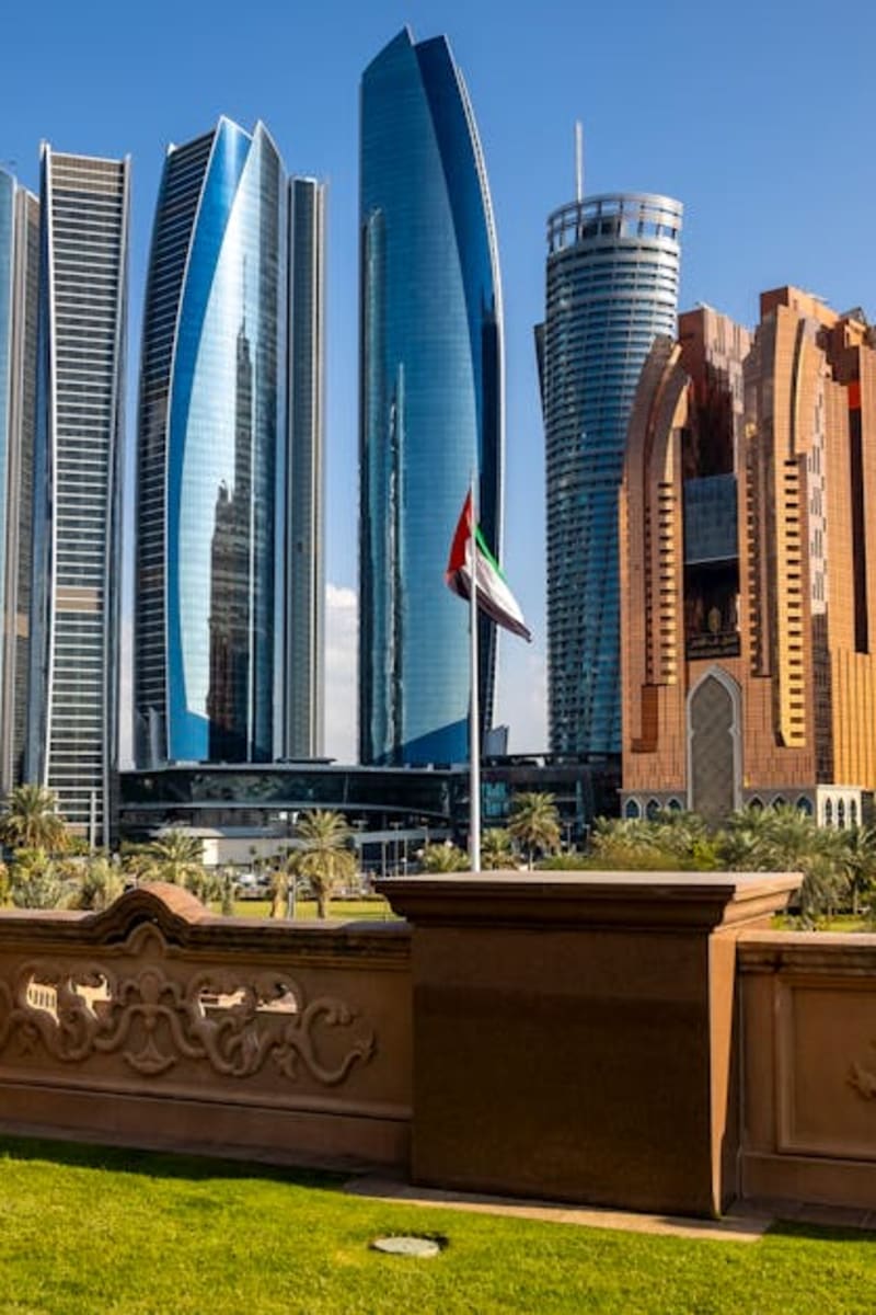 Stunning view of Abu Dhabi's Etihad Towers and city skyline under clear blue sky.
