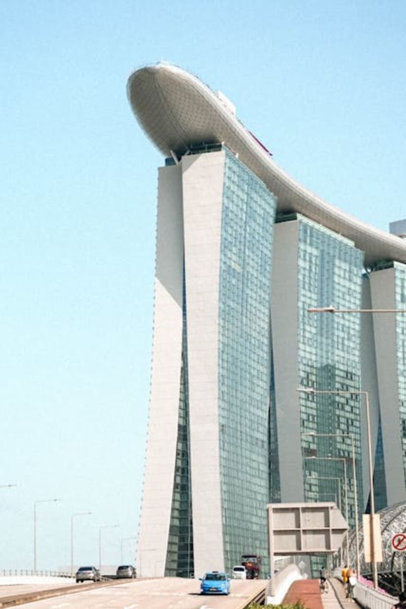 A clear daytime view of Marina Bay Sands in Singapore, showcasing its iconic architecture against a blue sky.