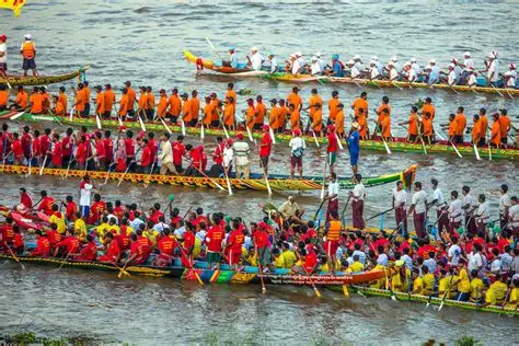 Cientos de remeros en barcos decorados en el río.