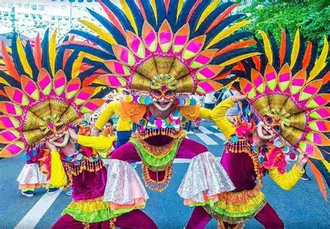 Bailarines con máscaras brillantes y sonrientes.