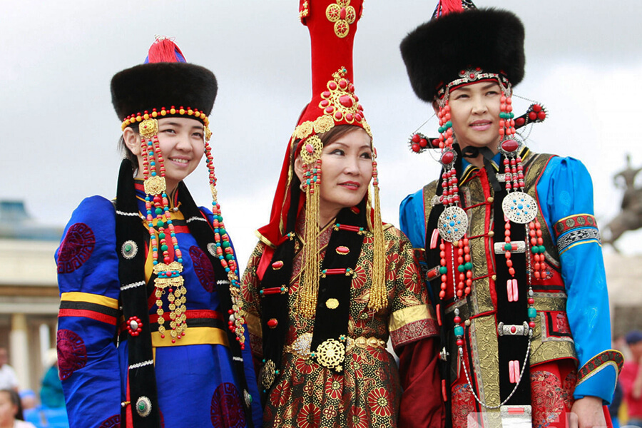 Modelos con trajes de piel y seda en dunas de arena.