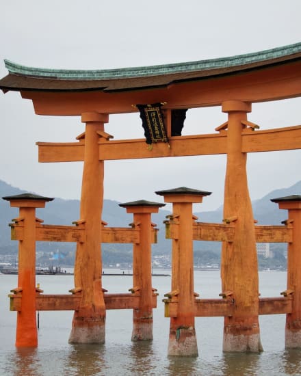 A torii gate standing in the water in Japan