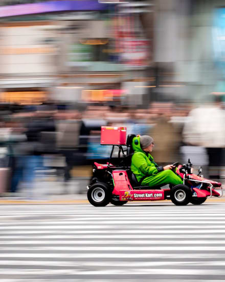 Mario Kart go-karts driving through the streets of Shibuya, Tokyo